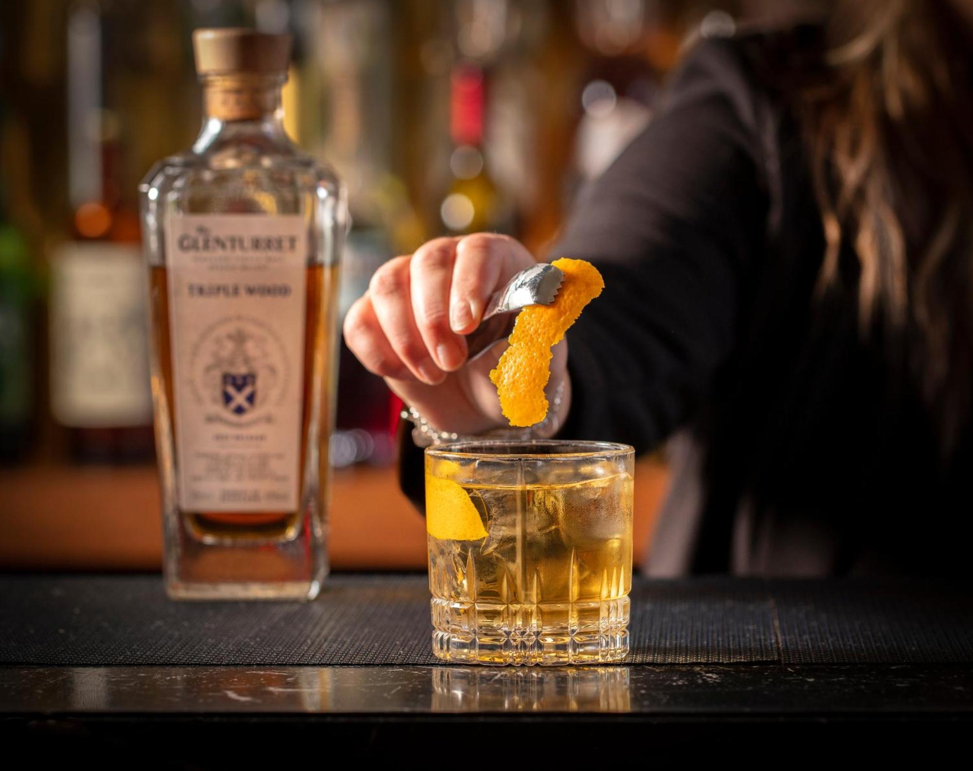 Schloss Roxburghe, Part Of Destination By Hyatt Exterior photo A bartender adding a lemon twist to a glass of GINfinity