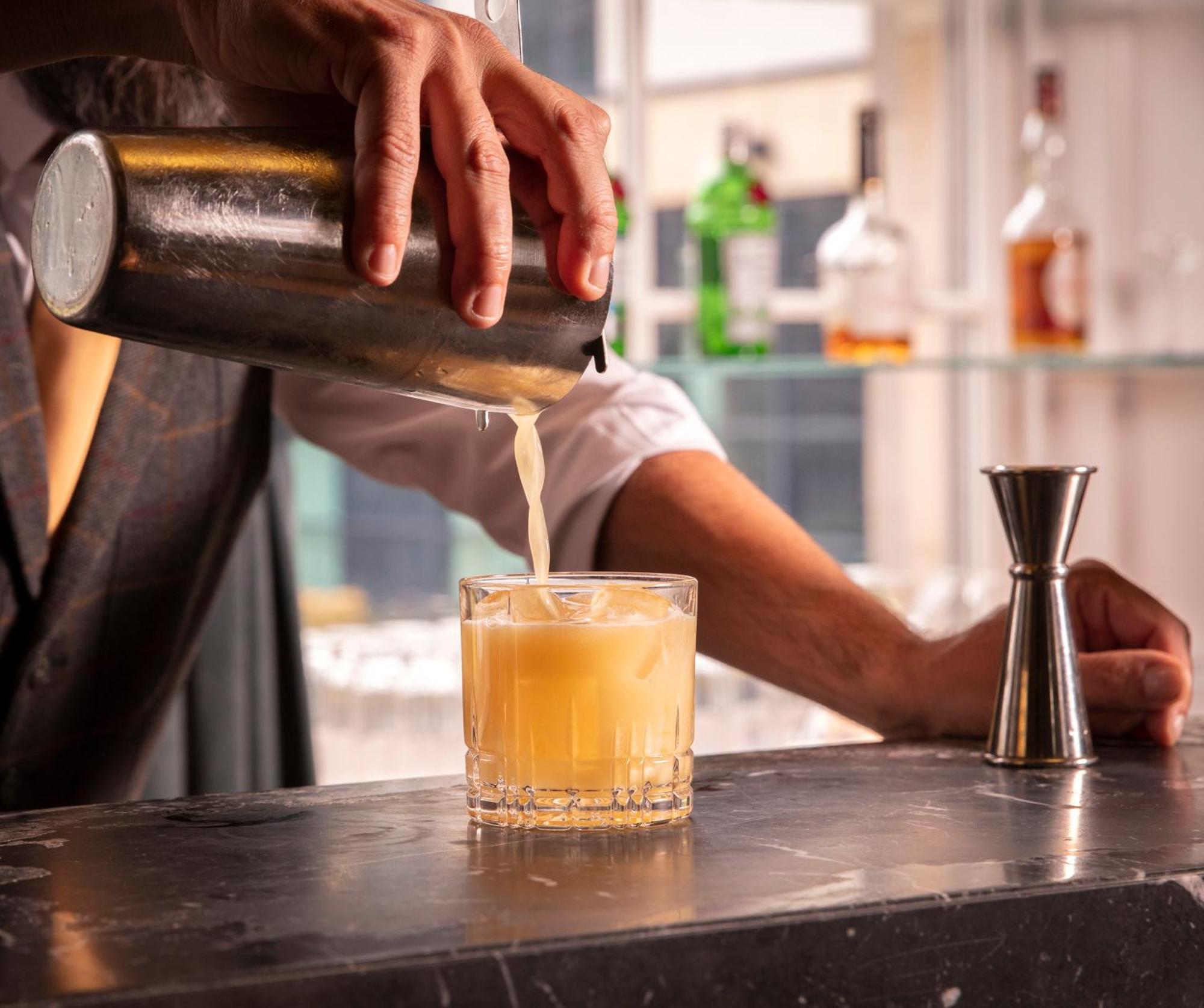 Schloss Roxburghe, Part Of Destination By Hyatt Exterior photo A bartender straining a cocktail